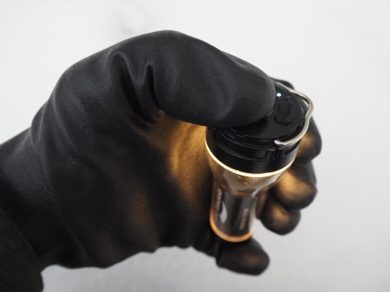 ワークマンの防寒防水手袋を着用したまま、キャンプ用LEDライトのスイッチを操作している様子